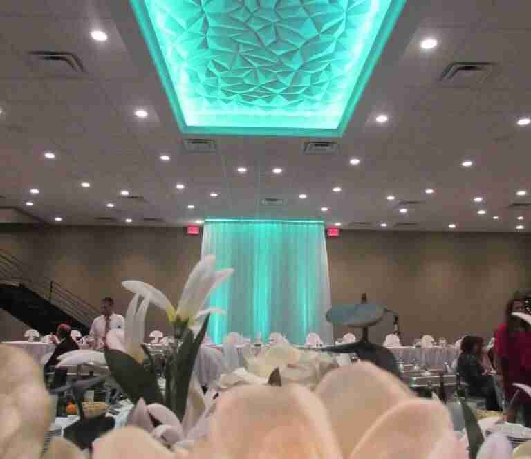 Close up of floral arrangements with teal lighting in Balconade Room
