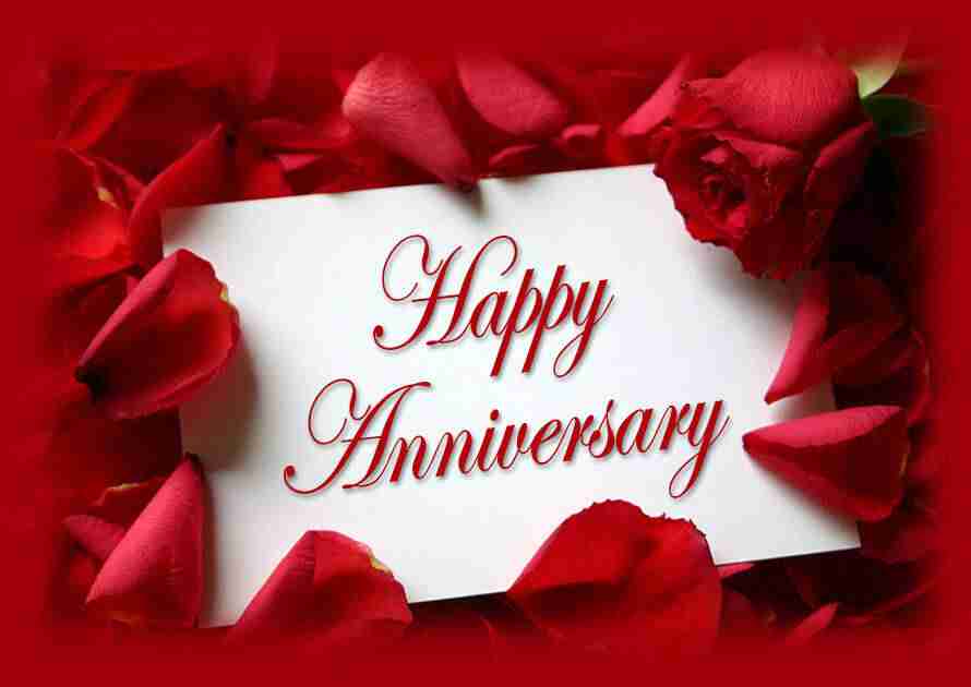 Happy Anniversary written on white card and surrounded by red flower petals for anniversary parties