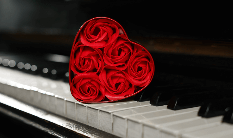 Red roses in the shape of hearts on piano keys for Valentine's night out