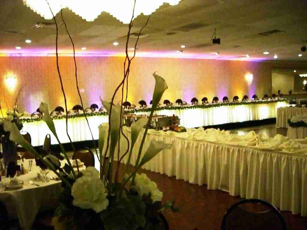 grand ballroom orchid arrangements with pink and yellow backdrop