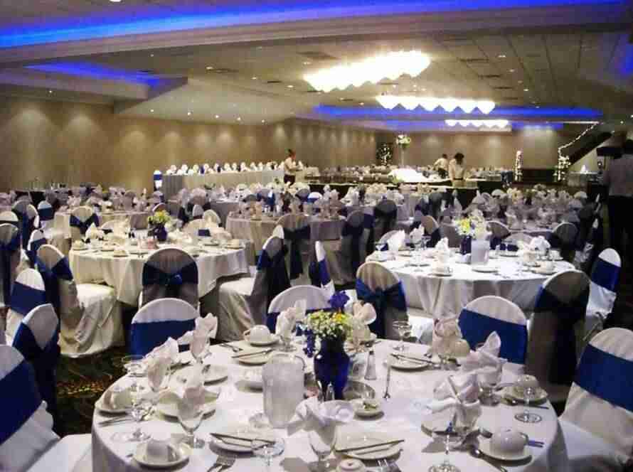 blue chair cover sashes and tabletop vases with floral arrangements for grand ballroom event