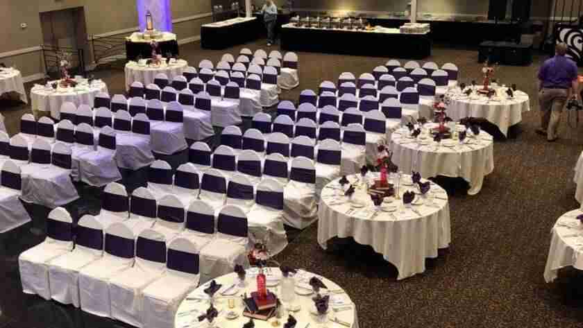 wedding ceremony setup for Balconade Room with white chair covers and black sashes