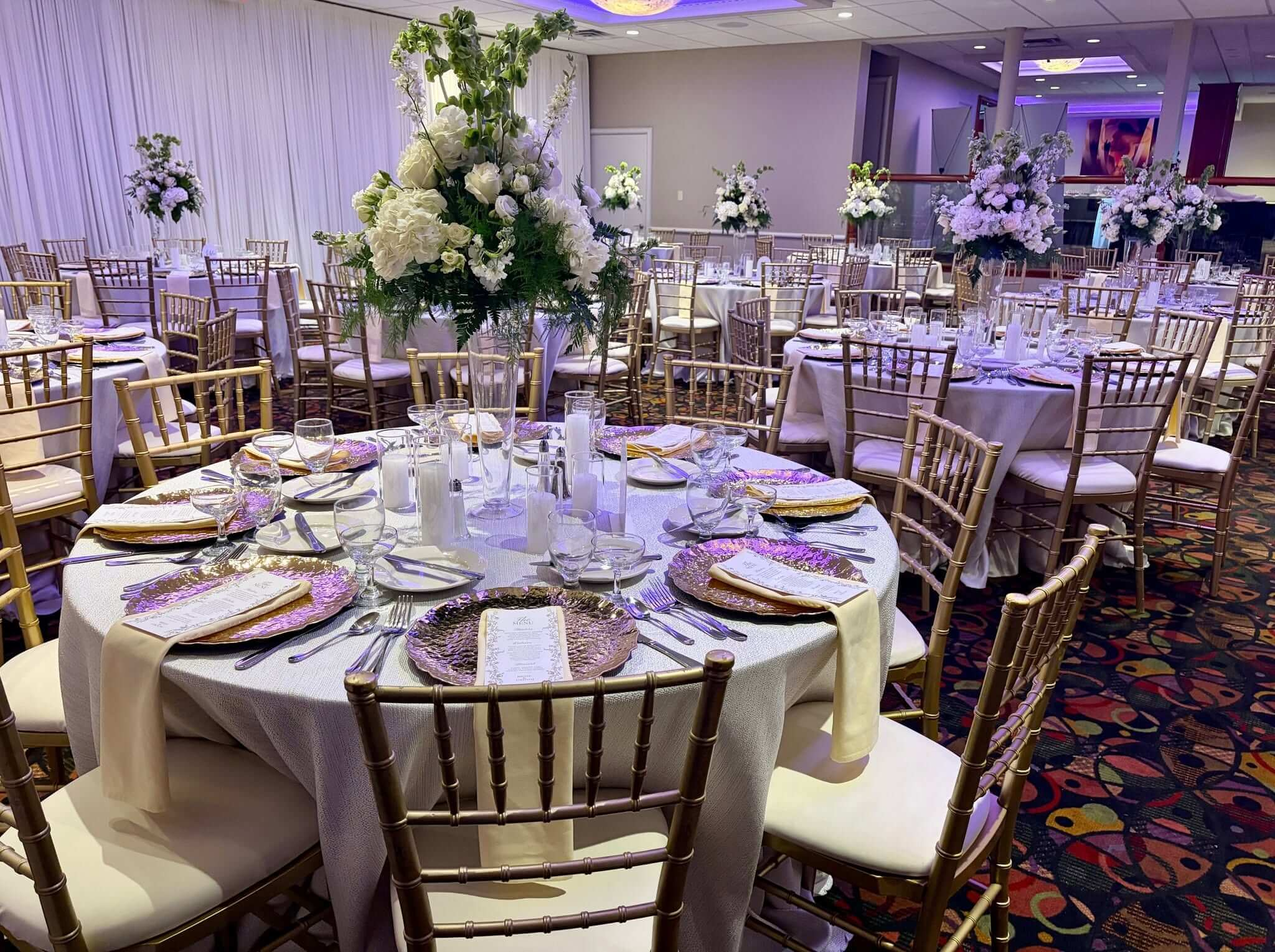 spring terrace room wedding reception decor with chivari rental chairs
