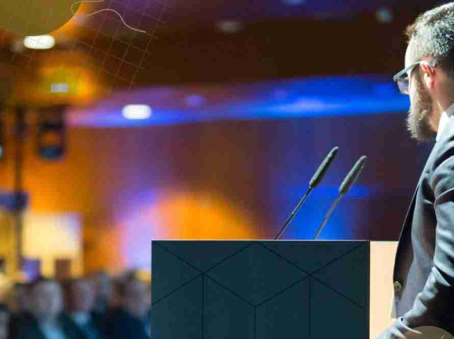 Speaker presenting to audience at an event venue