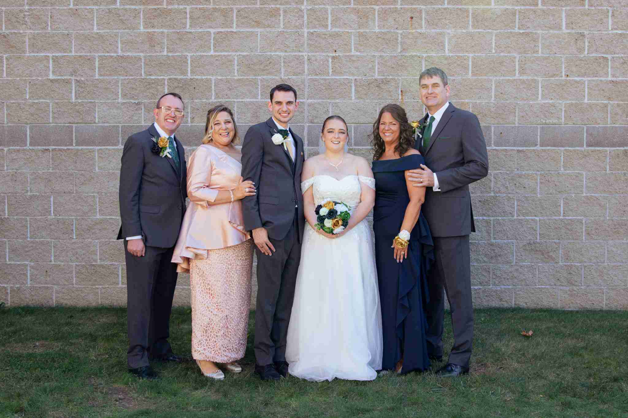 Bride and Groom with their parents on their wedding day