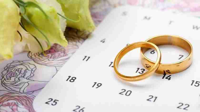 calendar with gold wedding rings and hearts to choose best date to get married in 2026 or 2027