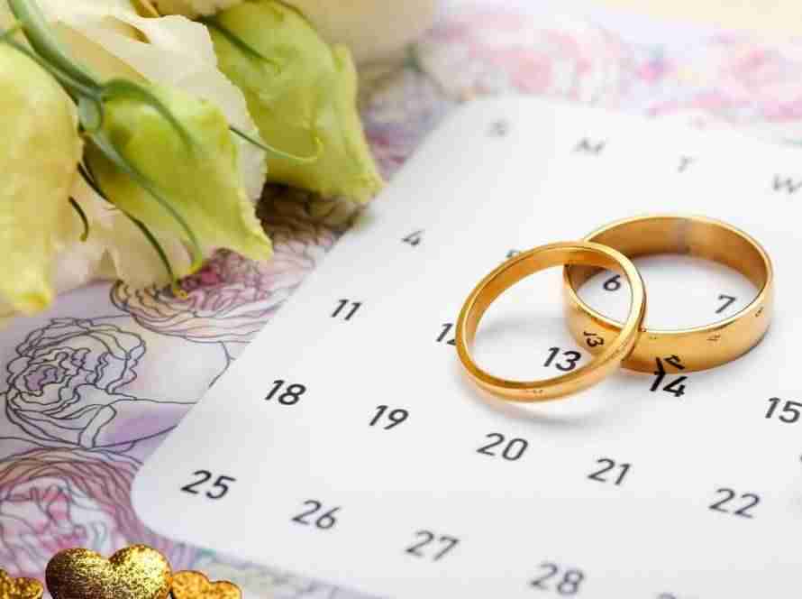 calendar with gold wedding rings and hearts to choose best date to get married in 2026 or 2027