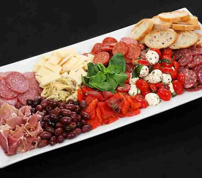 A colorful and savory spread of Italian-inspired favorites, our antipasto platter features an artful arrangement of cured meats with marinated vegetables and cheeses.