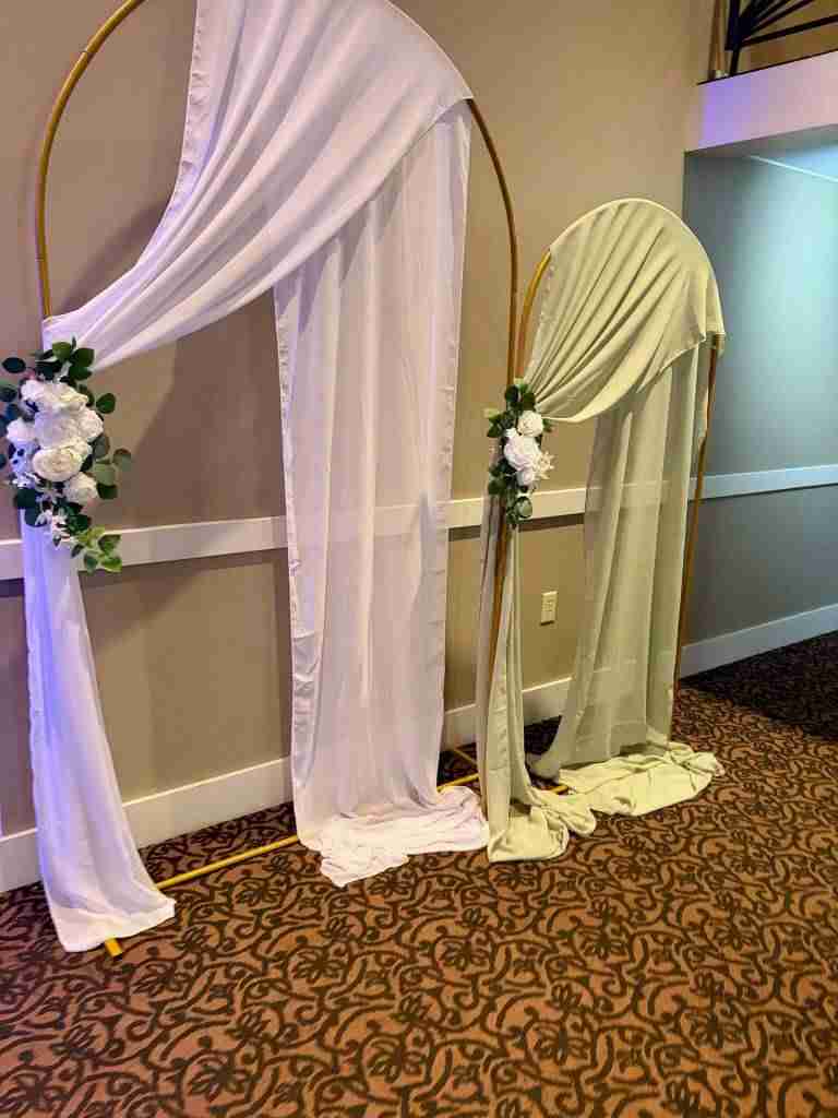 Arch accented by florals and draping