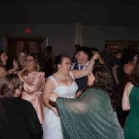 Guests celebrate with bride during wedding reception in Grand Ballroom