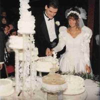 Bride and groom cutting wedding cake in October 1995