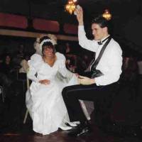 Bride and groom get ready for the garter toss in Balconade Room at their wedding reception in October 1995